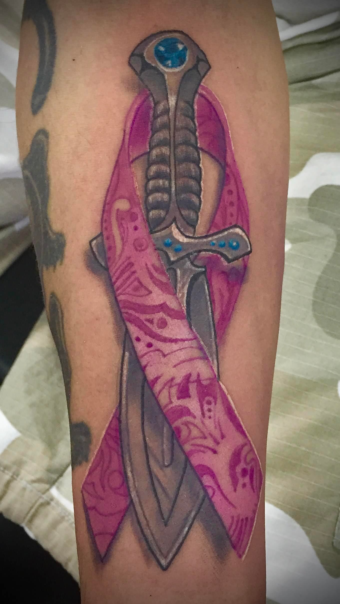 Cancer awareness ribbon with ornate dagger — Color Realism tattoo by Spade